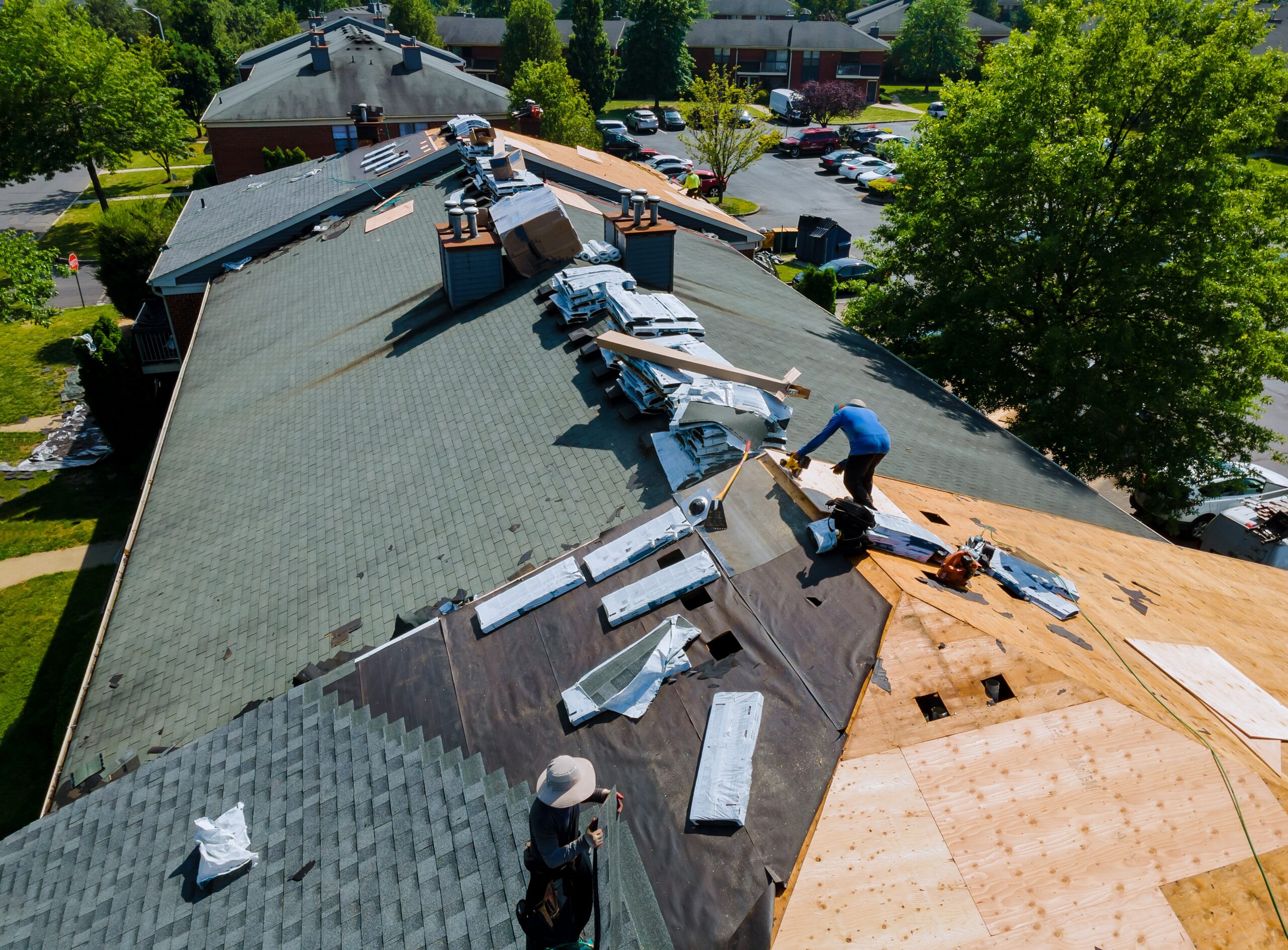 Réparation de toiture en cours sur bâtiment résidentiel.